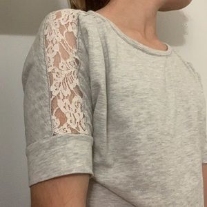 Grey woman’s half shirt with white lace on sleeves